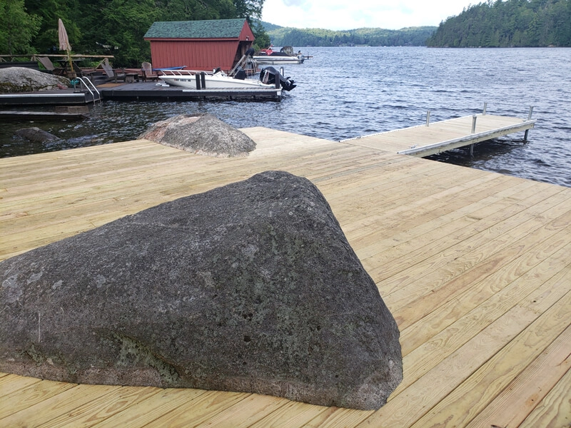 Waterfront home construction with dock and boathouse on a lake in the Adirondacks